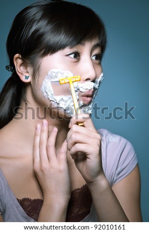 stock-photo-a-young-asian-girl-shaving-in-a-funny-role-reversal-92010161.jpg